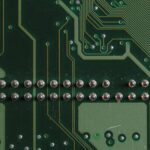 Detailed close-up image of a circuit board showcasing soldered components and circuit pathways.