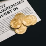 Close-up of Bitcoin coins on investment document promoting cryptocurrencies.