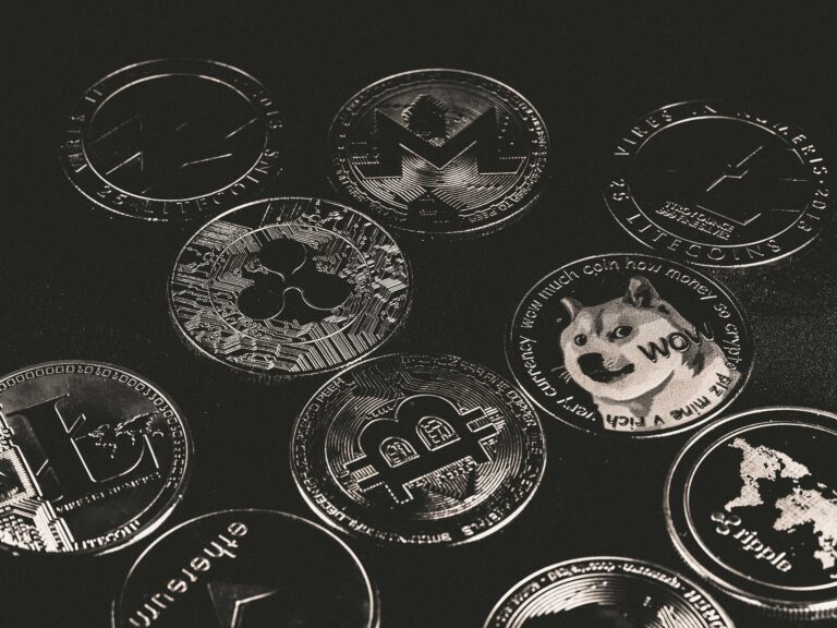 A collection of various cryptocurrency coins including Bitcoin, Ethereum, and Dogecoin.